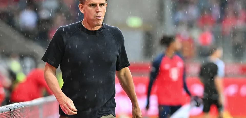 Coach walking on the sideline during rain
