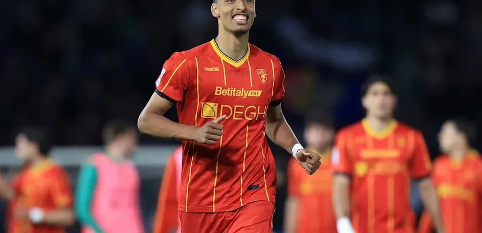 Player celebrating in red jersey after scoring goal