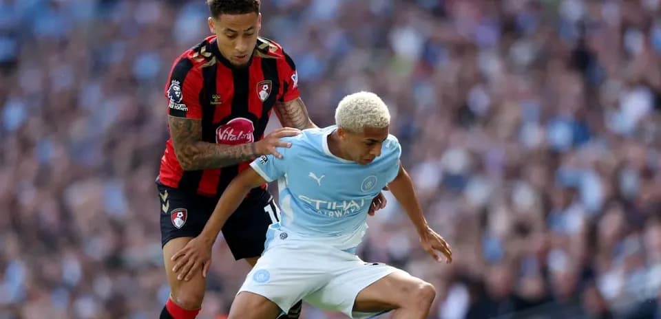 Bournemouth player tackling Manchester City player during match
