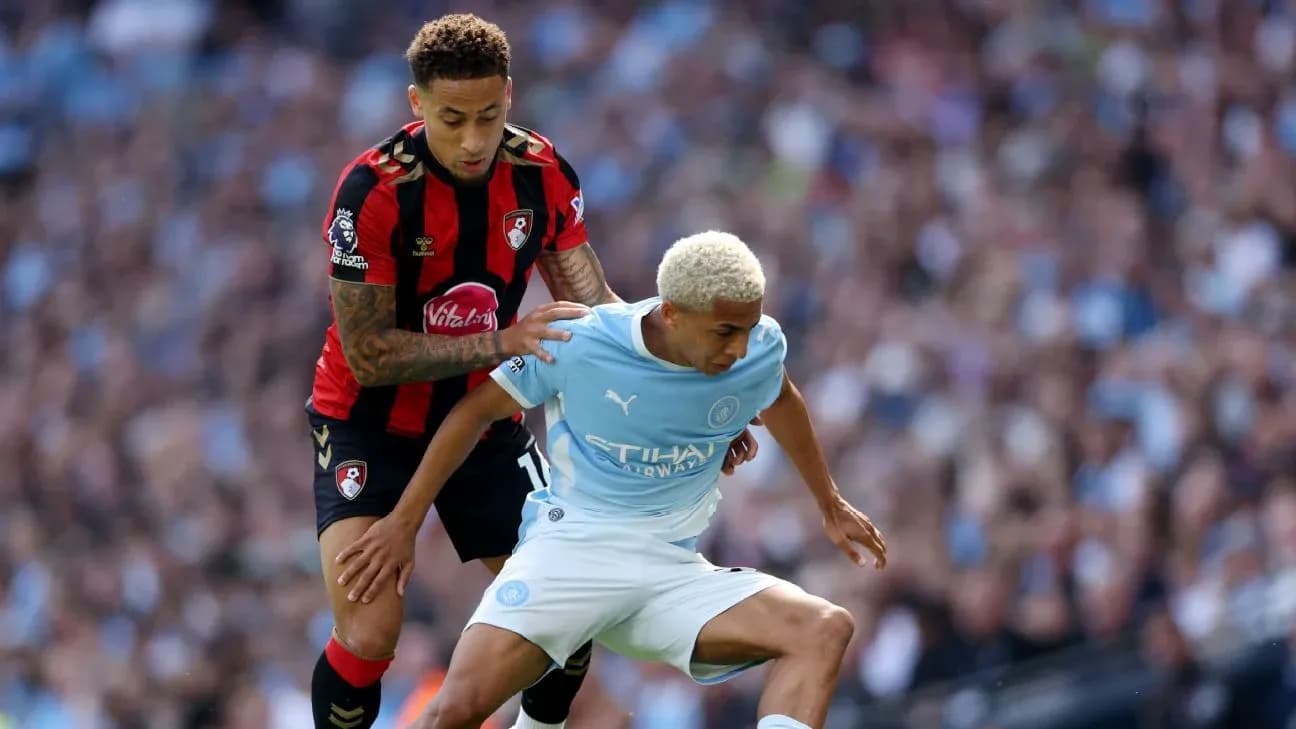 Bournemouth player tackling Manchester City player during match