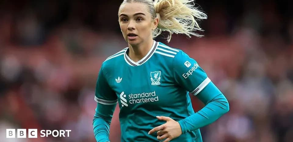 Player in teal Liverpool kit running on pitch