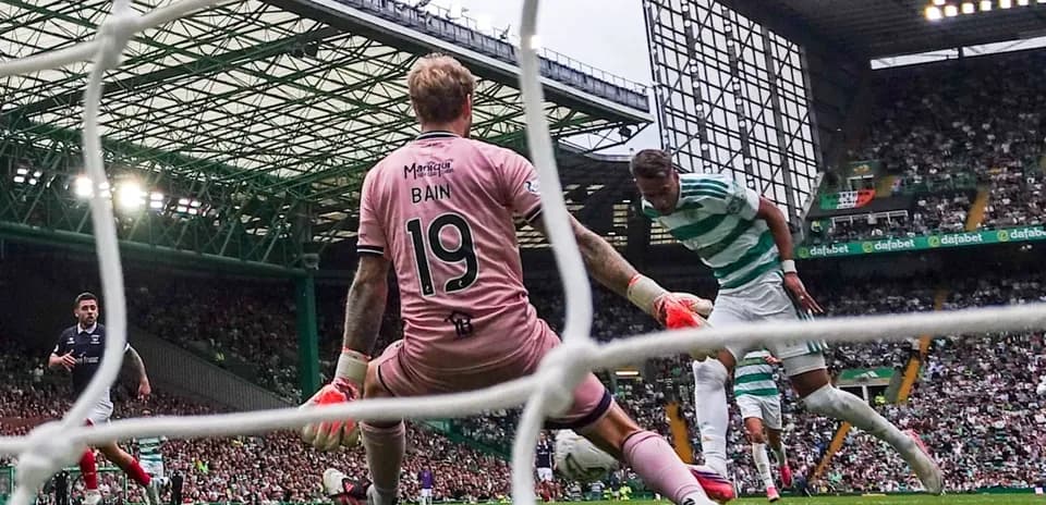 Goalkeeper attempting to block shot on goal