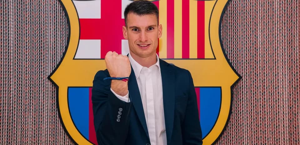 Player showing fist with Barcelona logo backdrop