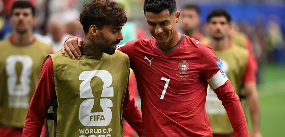 Two Portugal players chatting during warm-up session
