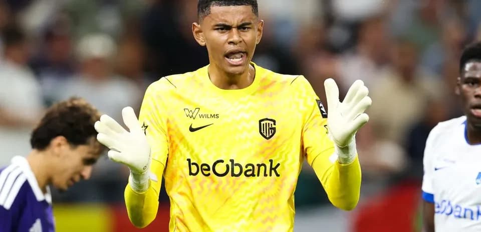 Goalkeeper gesturing during match with teammates nearby