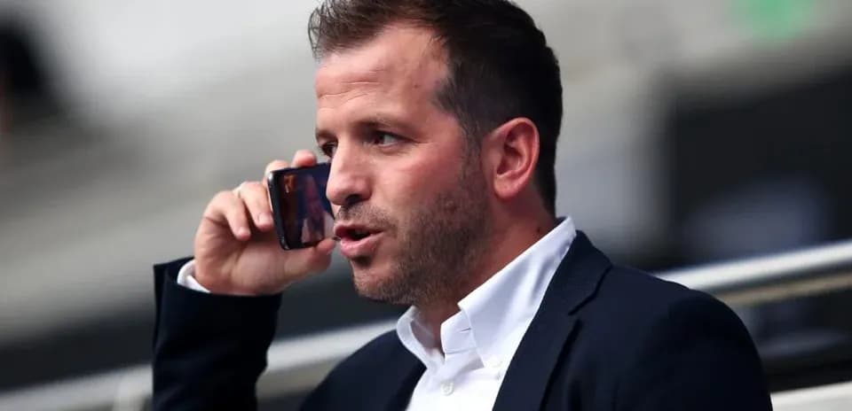 Man talking on phone in a stadium seat