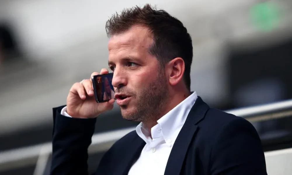 Man talking on phone in a stadium seat