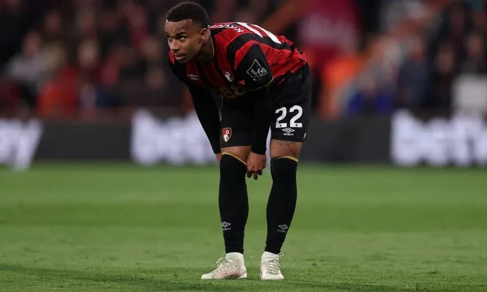 Player in Bournemouth kit bending over on field