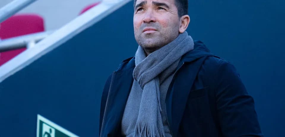 Person wearing a scarf looking up thoughtfully