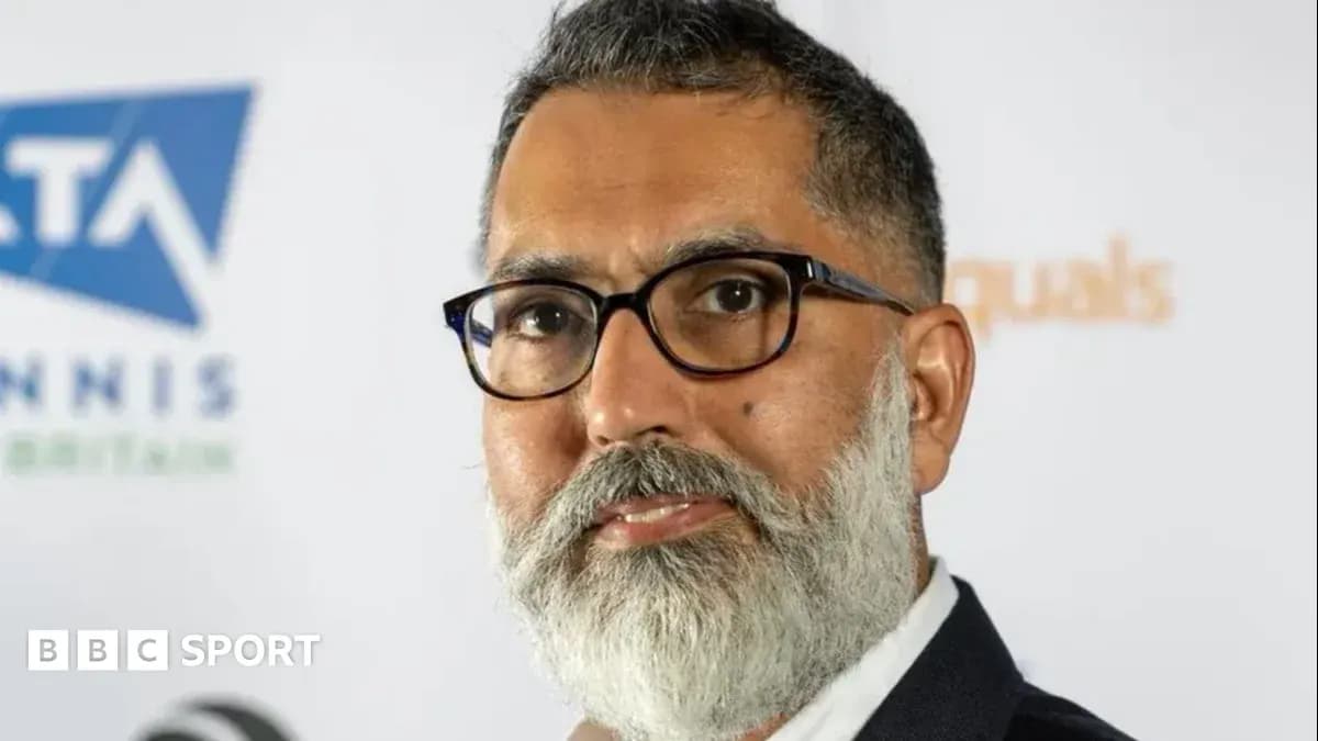 Man with glasses and beard at press event