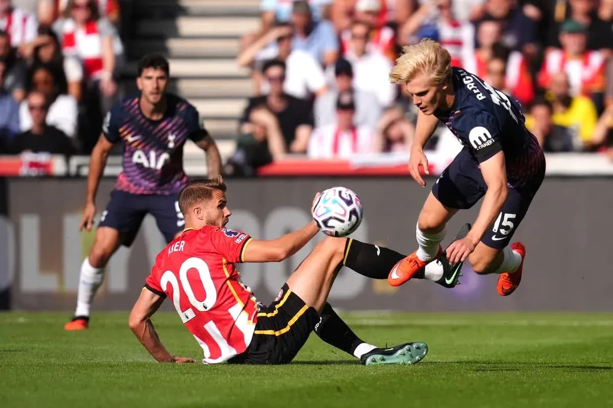 Player tackling opponent during football match action