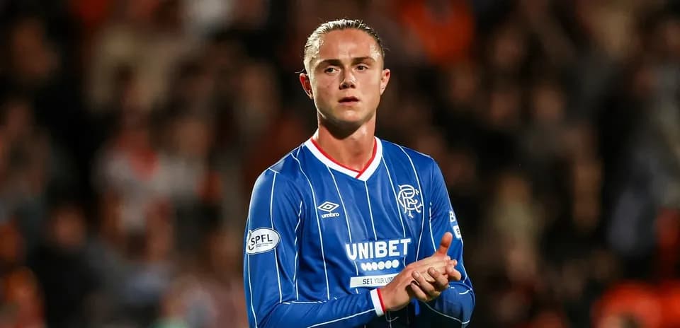 Player applauding fans while wearing Rangers jersey