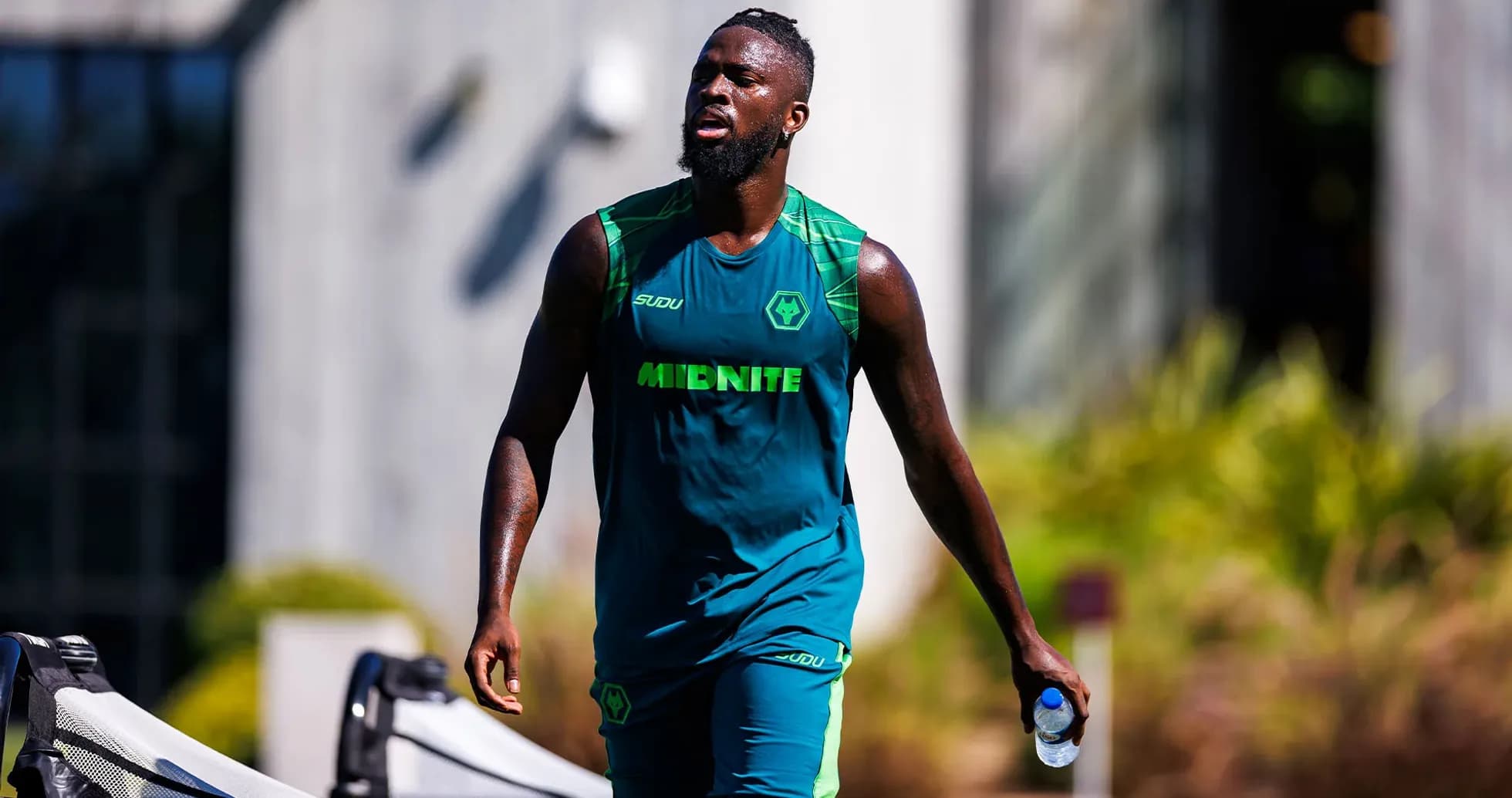 Player walking with water bottle during training session