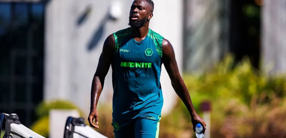 Player walking with water bottle during training session