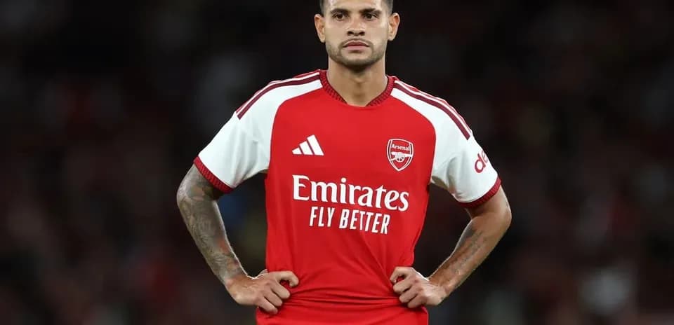 Player in Arsenal kit standing on the pitch