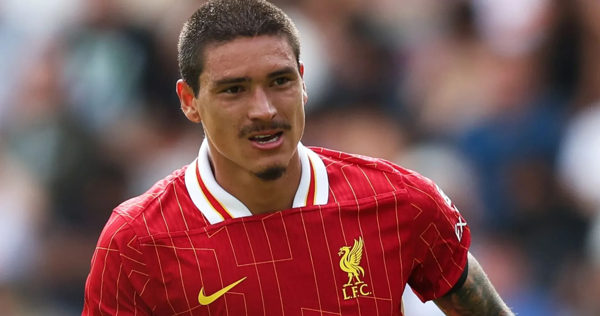 Player in Liverpool jersey running on the field