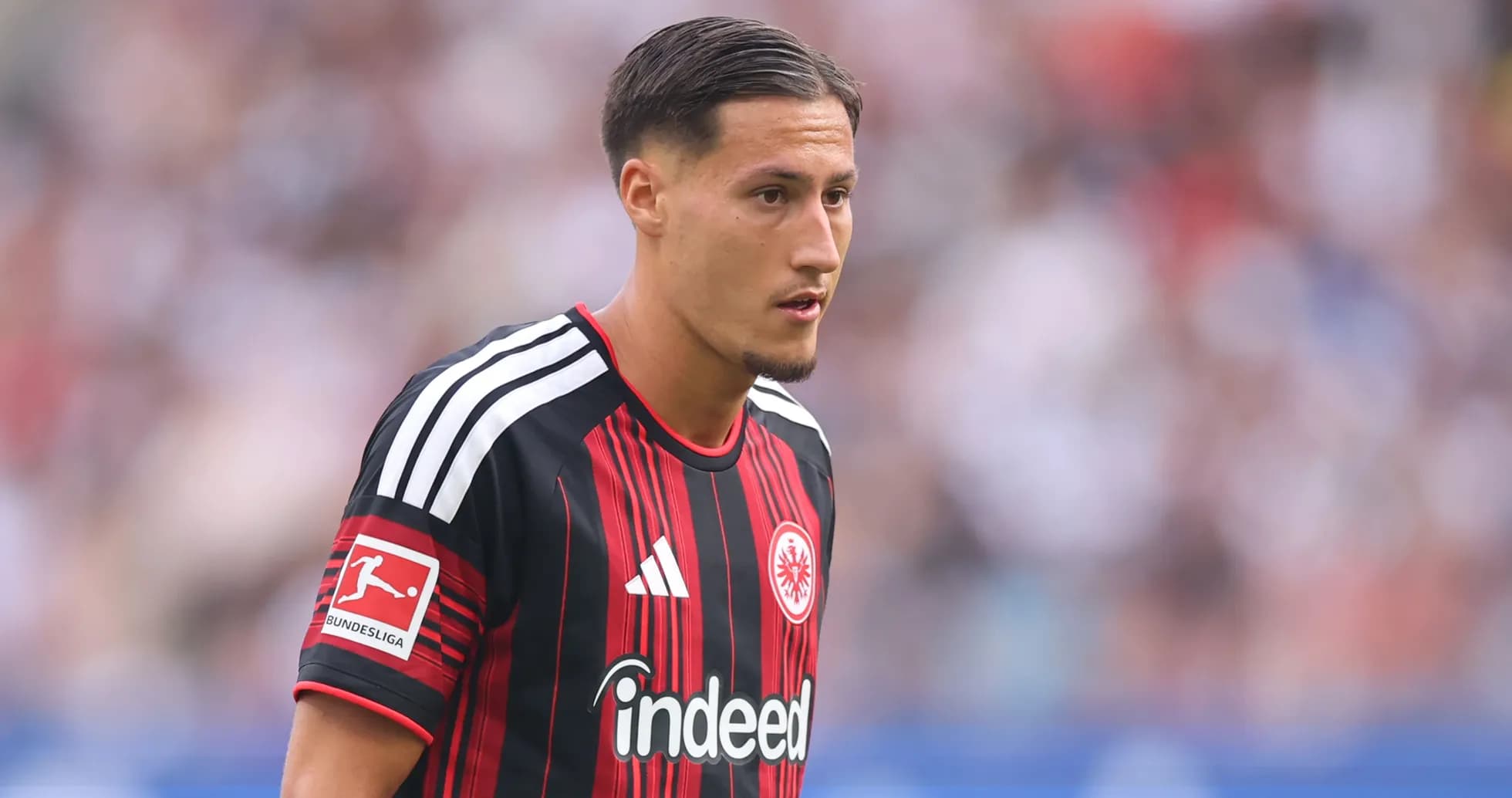 Player wearing Eintracht Frankfurt jersey on field
