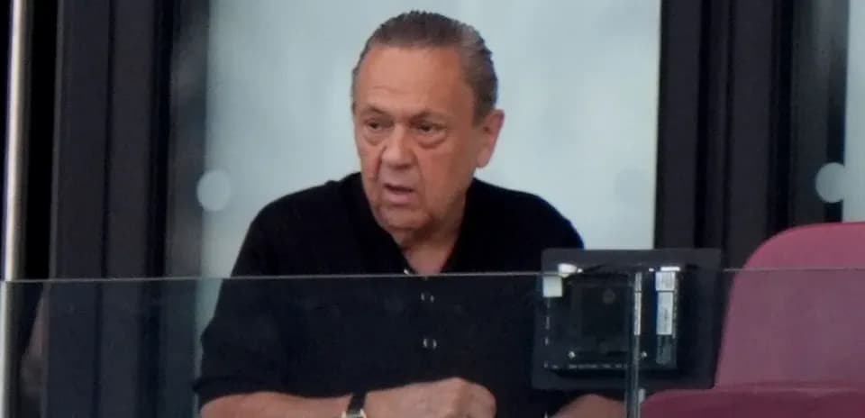 Man in a black shirt observing from a box