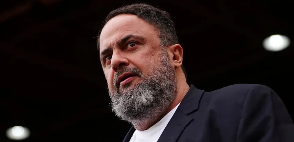Man with beard speaking at an event