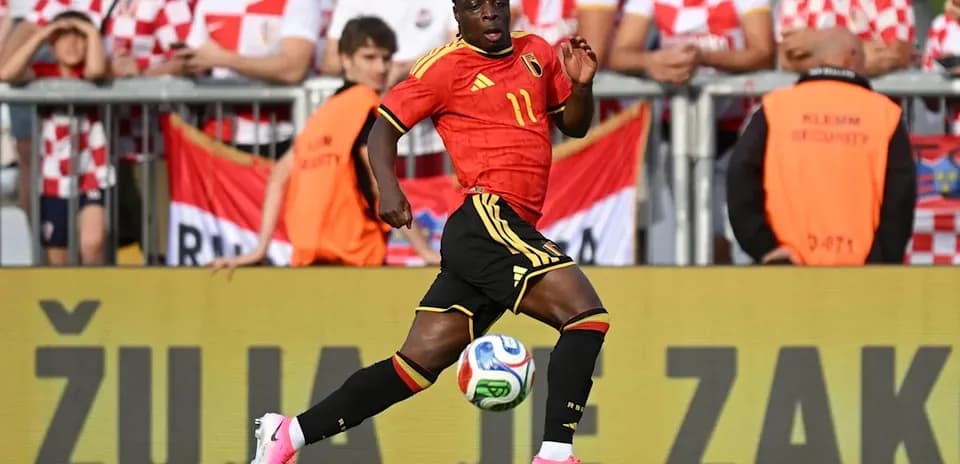 Player in Belgium kit running with ball during match