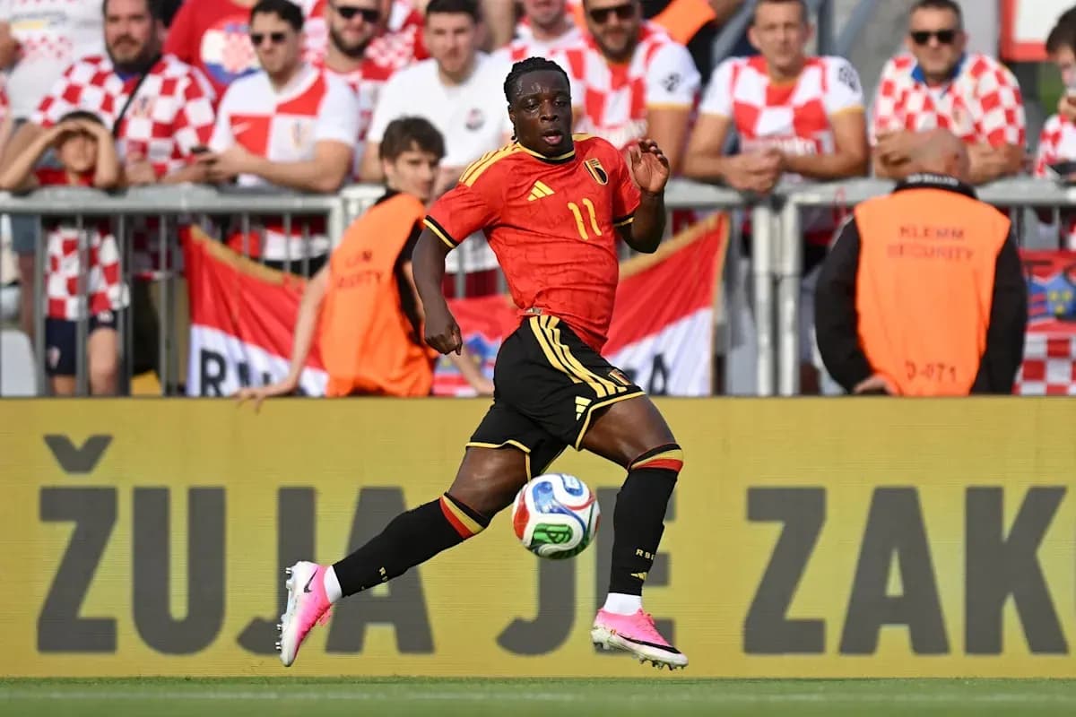 Player in Belgium kit running with ball during match