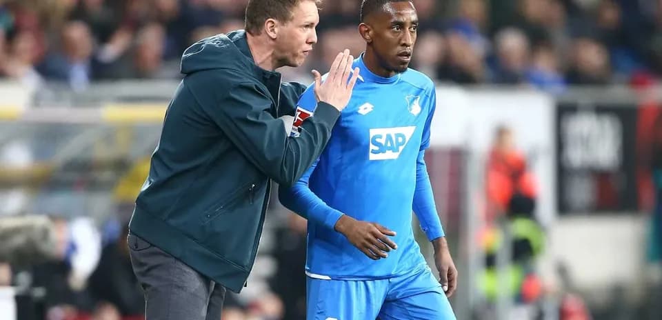 Coach giving instructions to player on sidelines