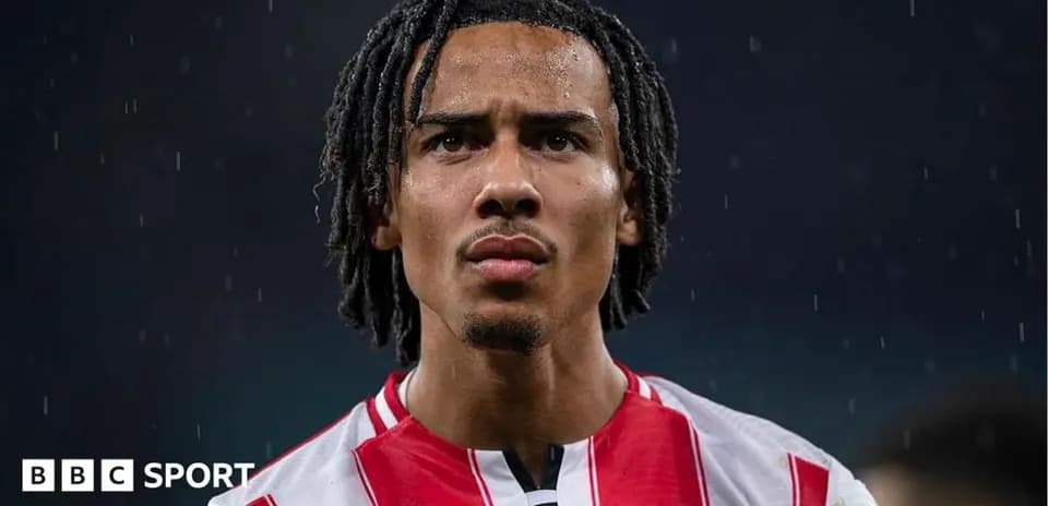 Brentford player focused during rain on pitch