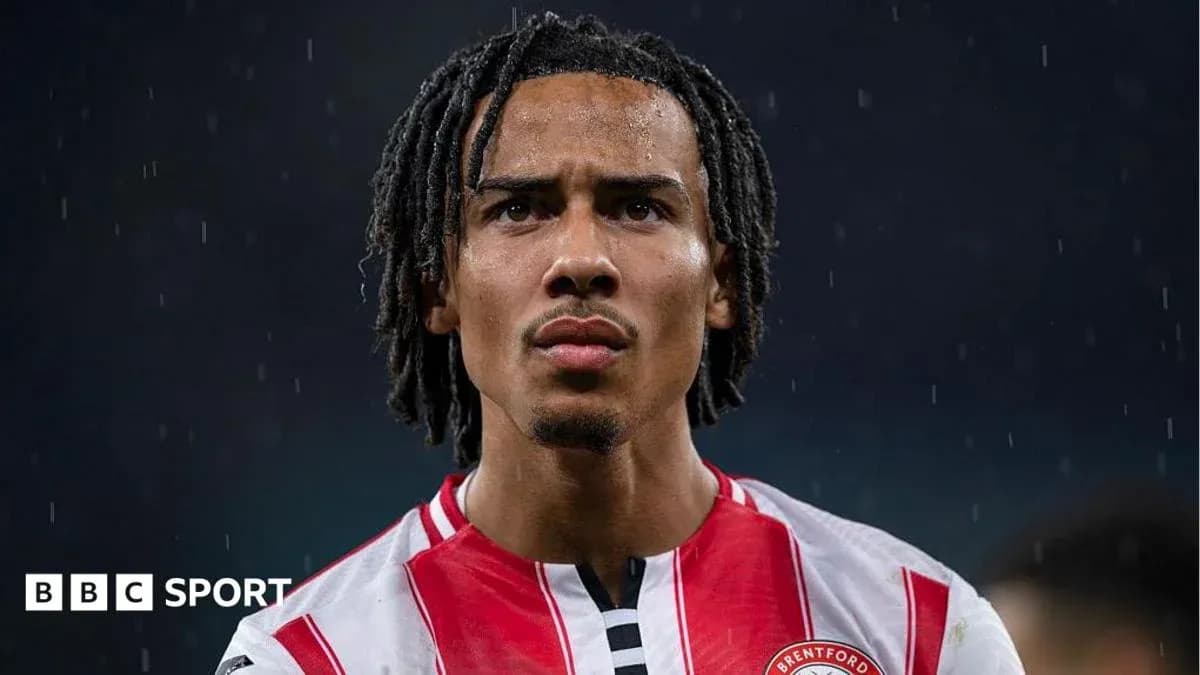 Brentford player focused during rain on pitch