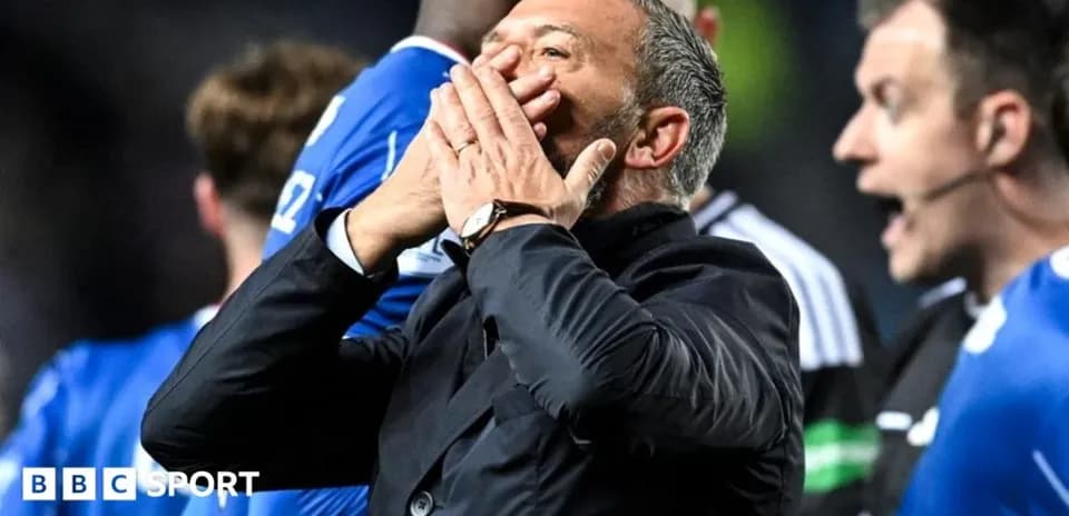 Coach reacting during match with players nearby