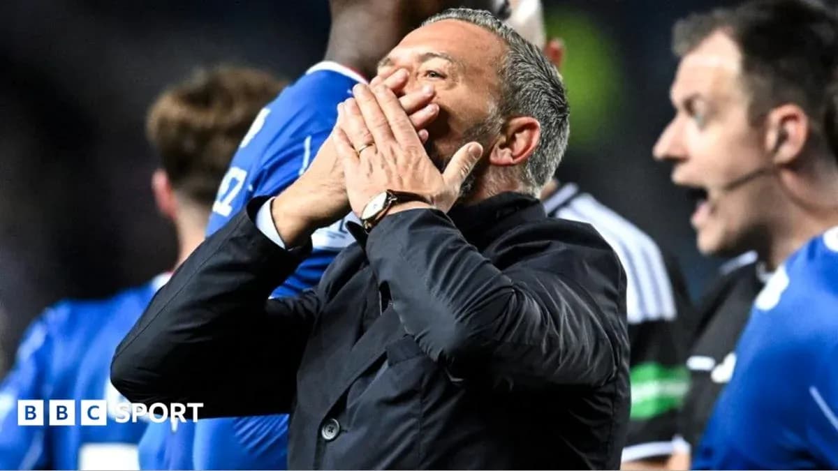 Coach reacting during match with players nearby