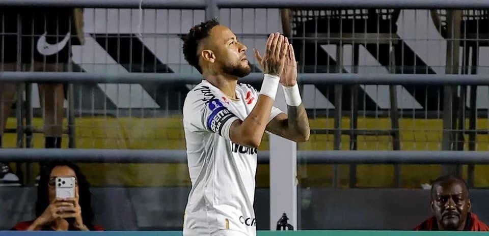 Player celebrating with hands together on field