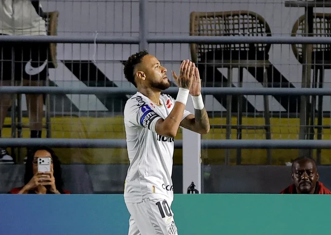 Player celebrating with hands together on field