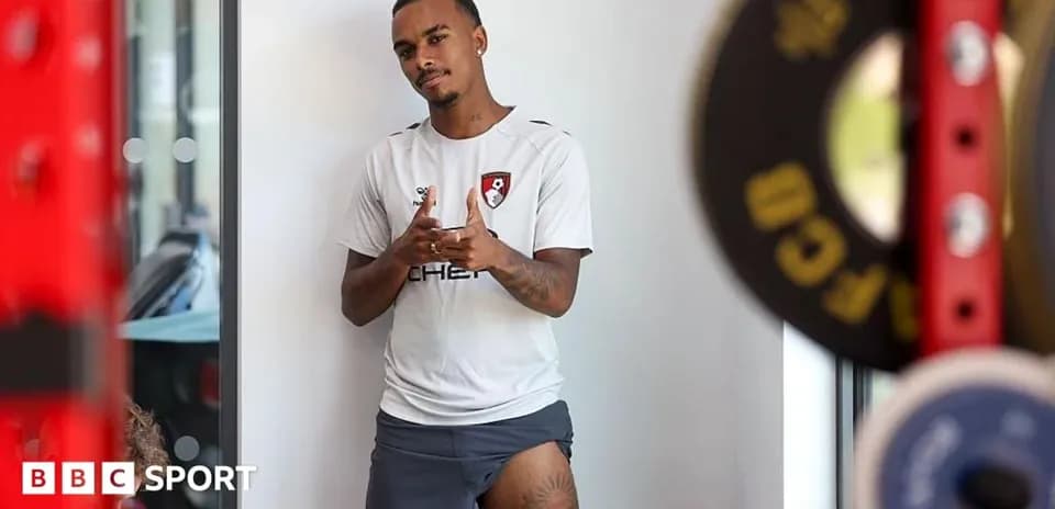 Player in Bournemouth training kit posing indoors