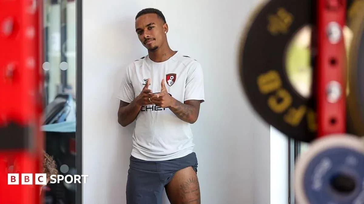 Player in Bournemouth training kit posing indoors