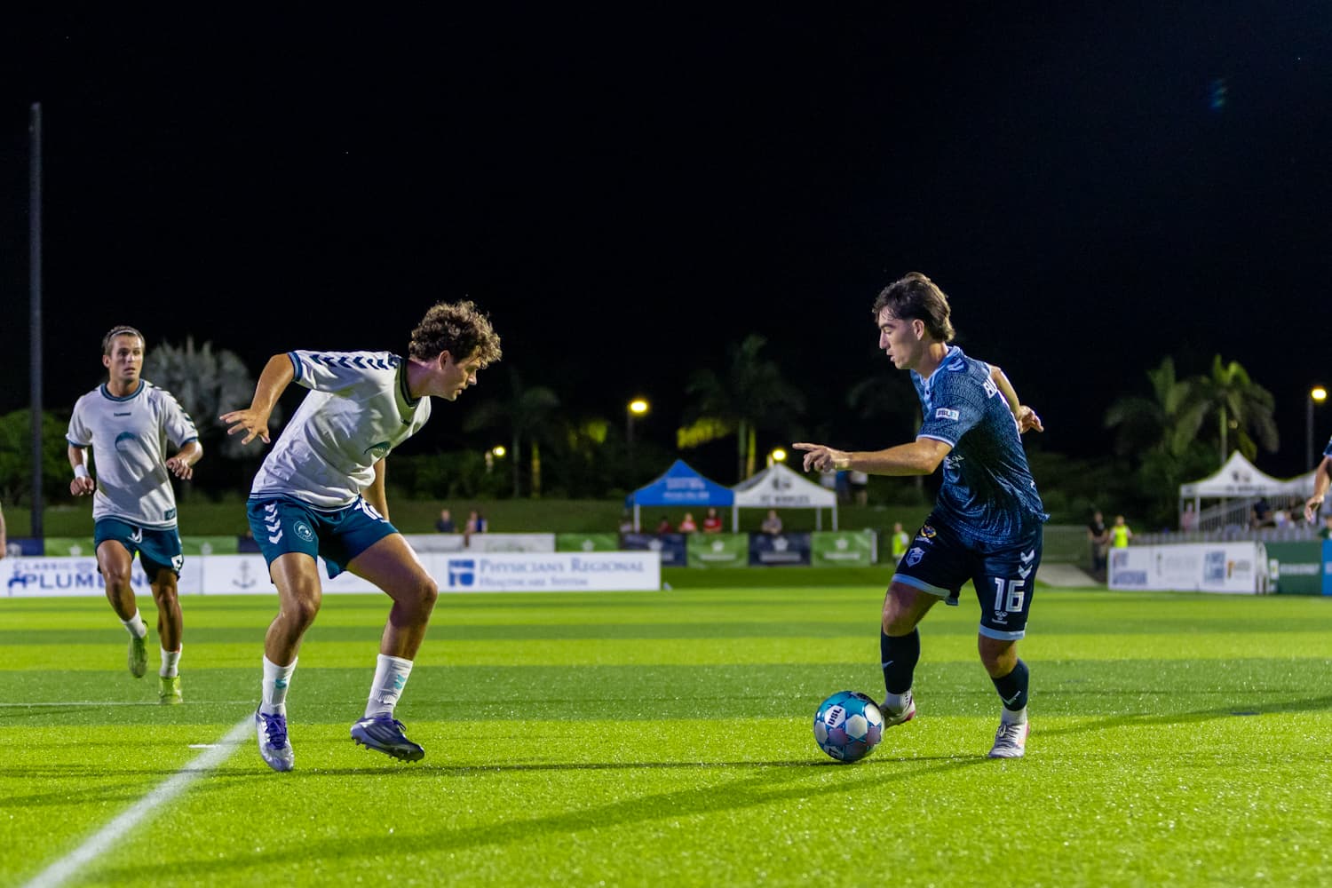 Players competing for the ball during match
