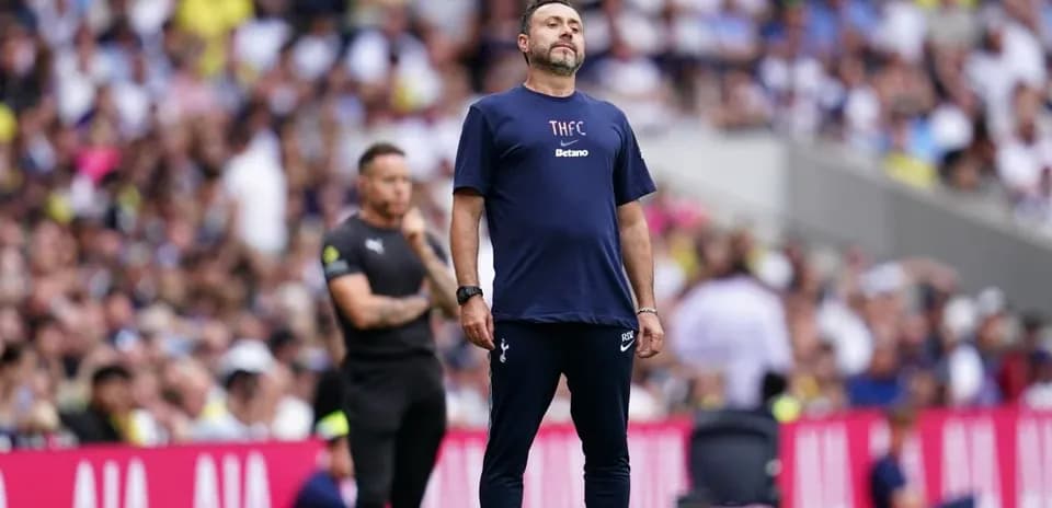 Coach observing match from sidelines during game