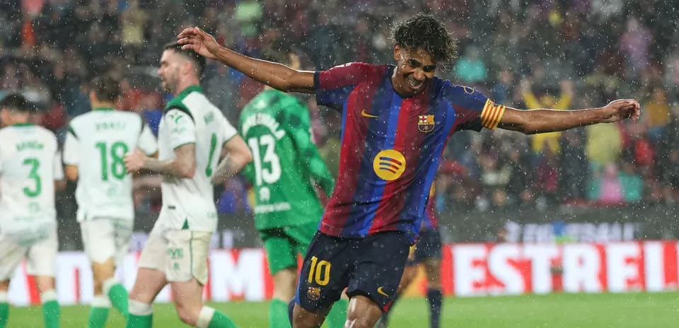 Player celebrating a goal during rainy match