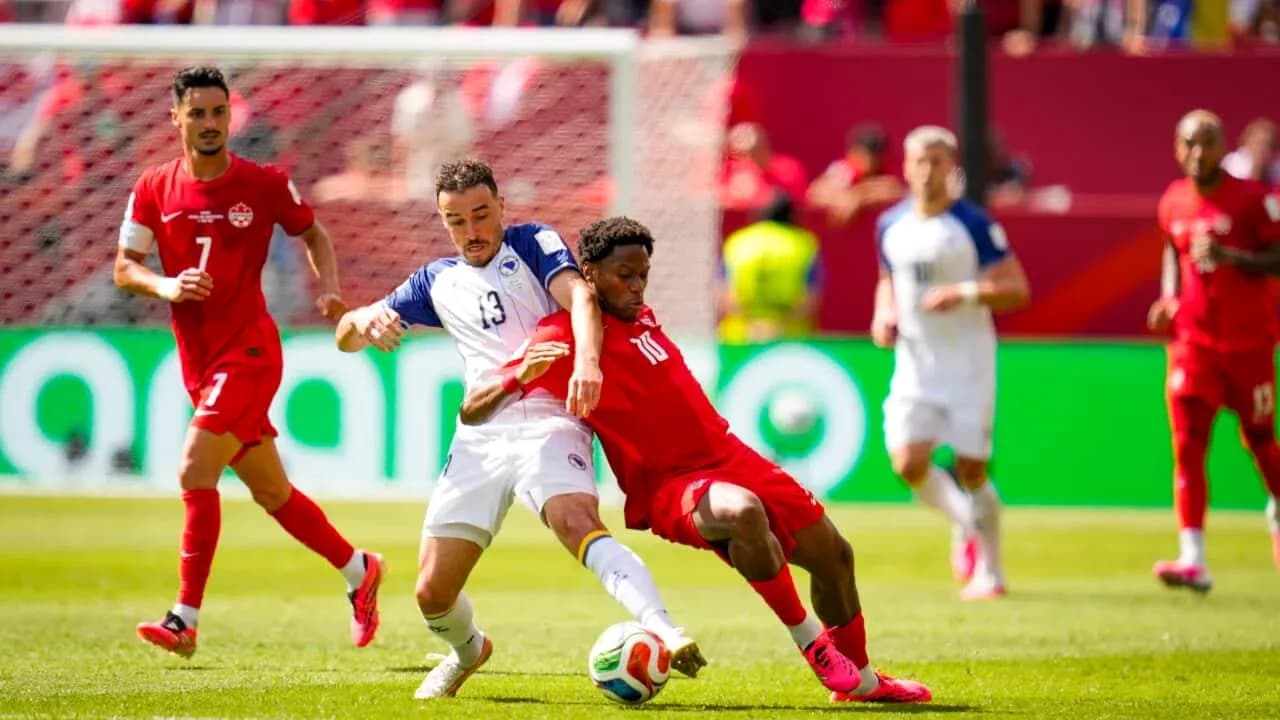 Canada player tackling Bosnia player during match
