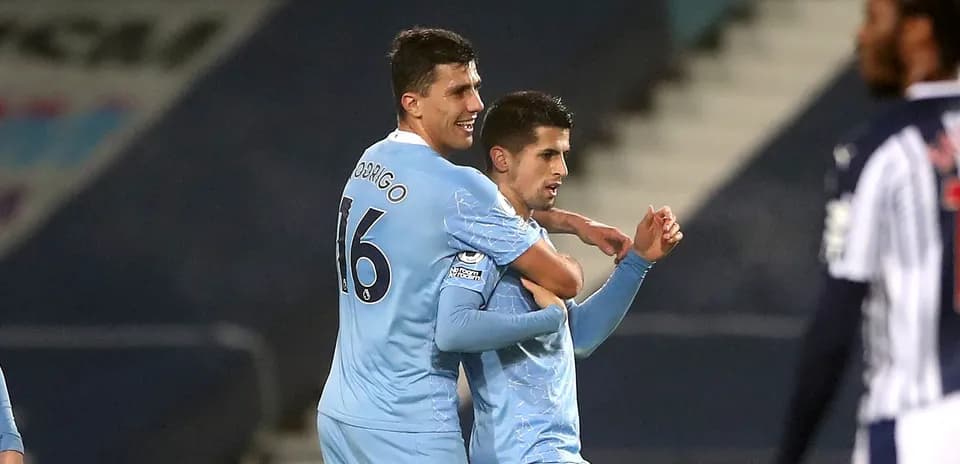 Two players celebrating a goal on the field