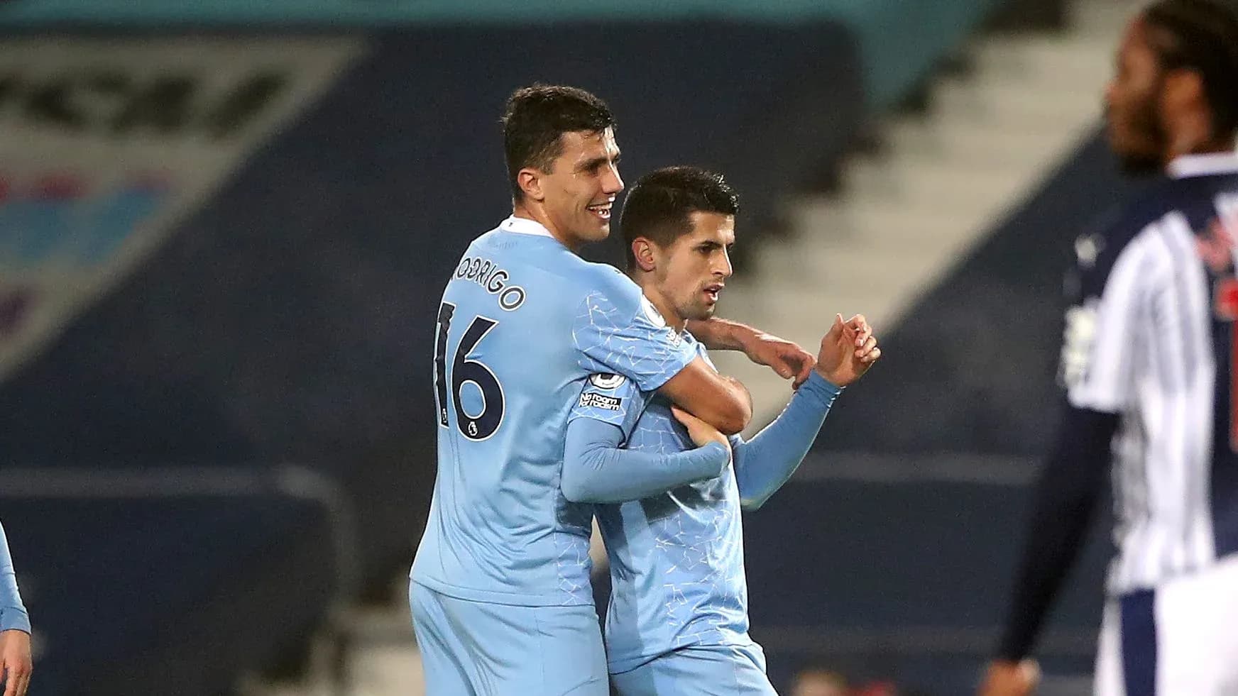 Two players celebrating a goal on the field