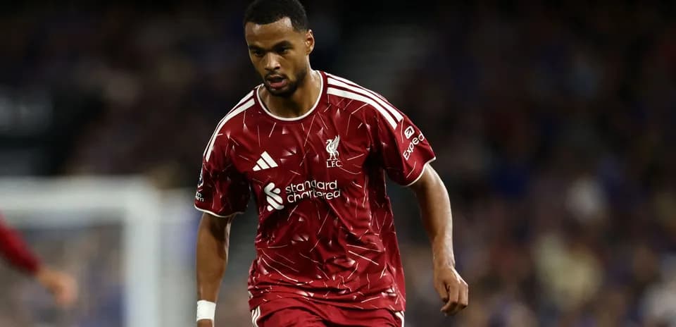 Player in Liverpool kit running on the field