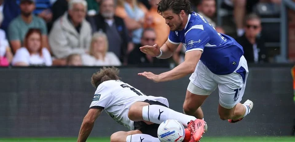 Player falling after a challenge during football match