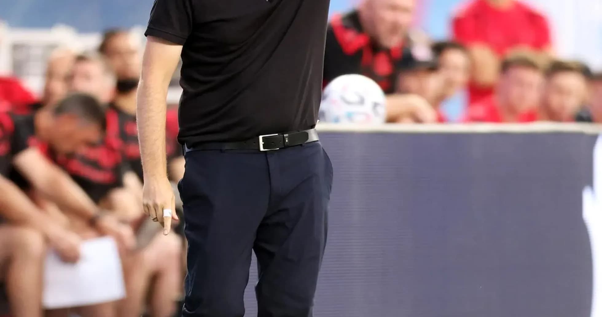 Coach directing players from the sideline during match