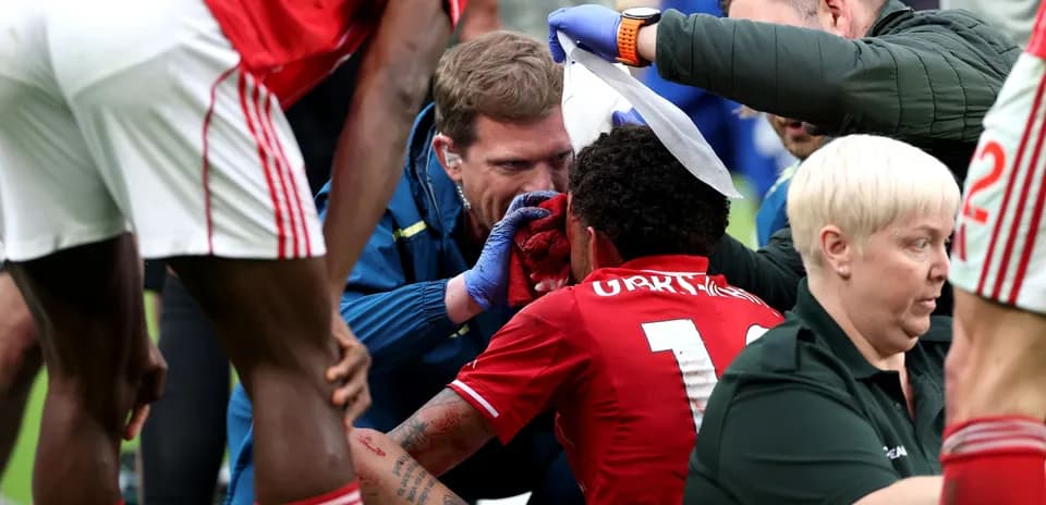 Medical staff treating injured player on the field