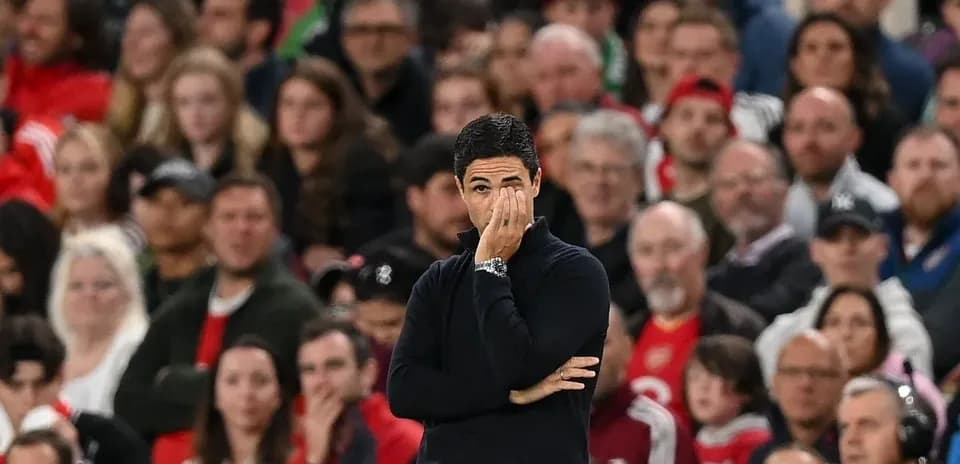 Manager observing the game with concerned expression