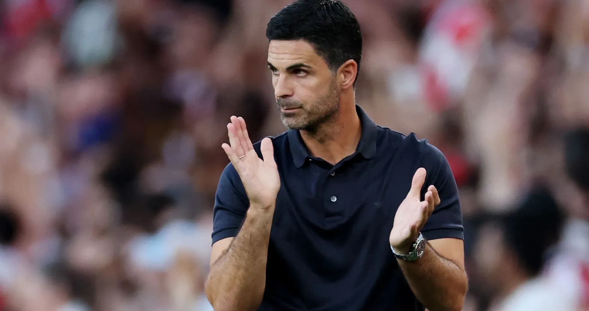 Coach gesturing and applauding during match