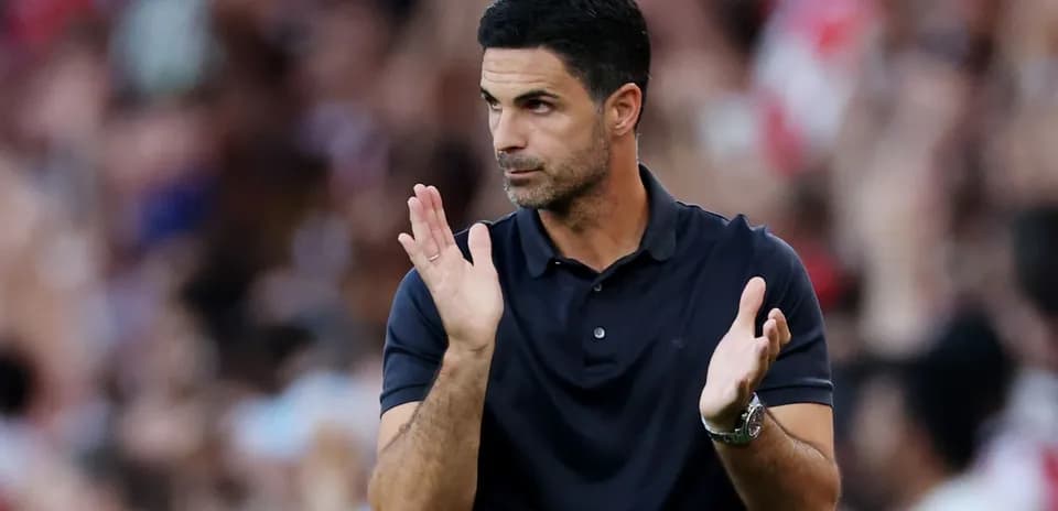 Coach gesturing and applauding during match