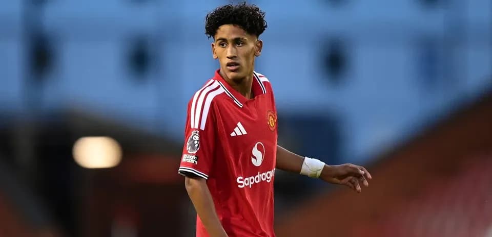Player wearing red Manchester United jersey on field