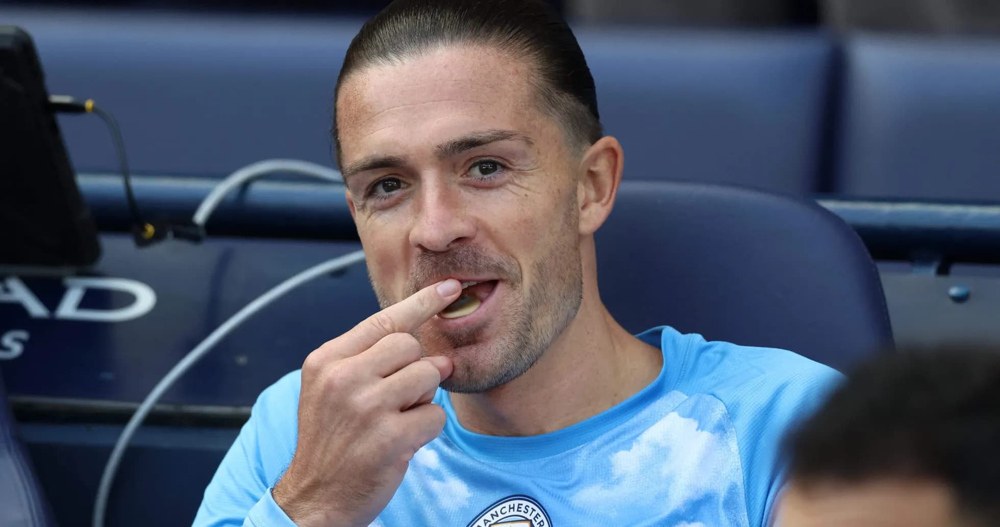 Player sitting on bench eating during match