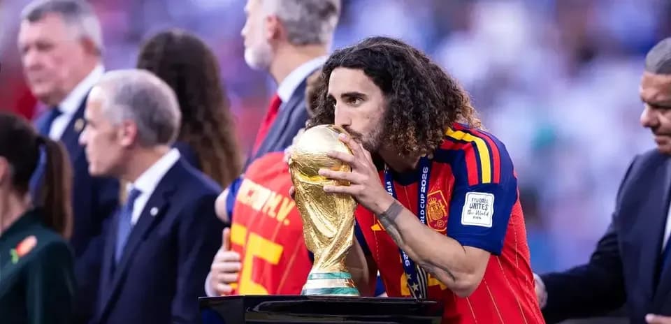 Player kissing FIFA World Cup trophy on podium